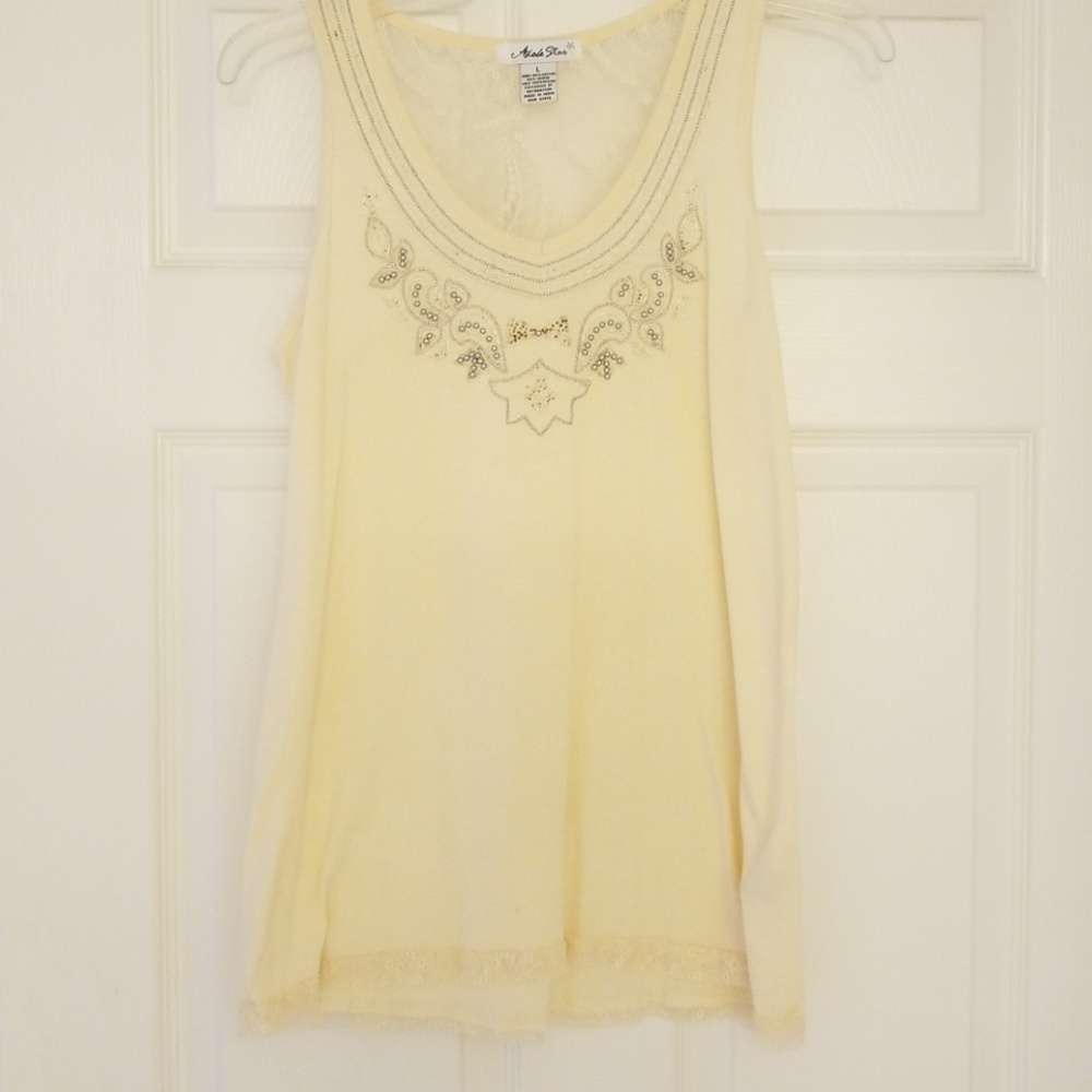 Very pretty cream colored and embellish thank top